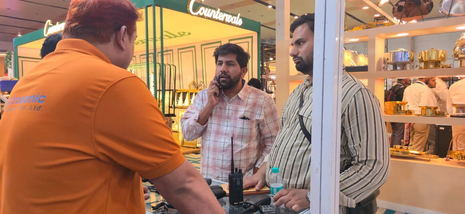 Electrosonic team speaking with exhibition visitors about radio communication