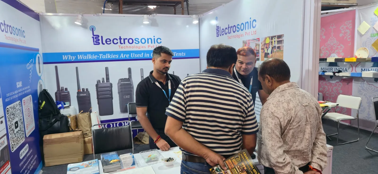 Electrosonic staff discussing radio communication products with visitors
