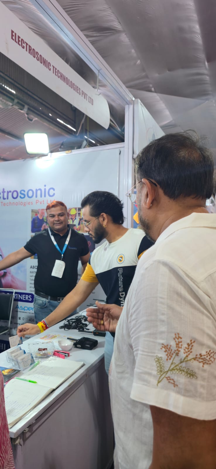 Visitors discussing communication products at the Electrosonic booth in Ludhiana